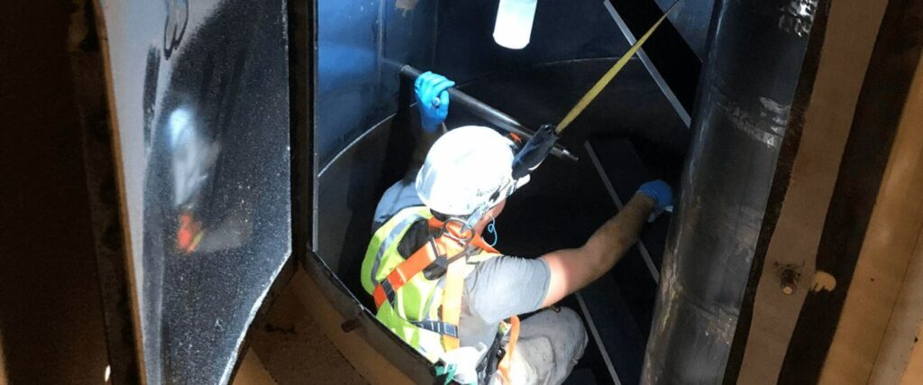 Man Cleaning Confined Space